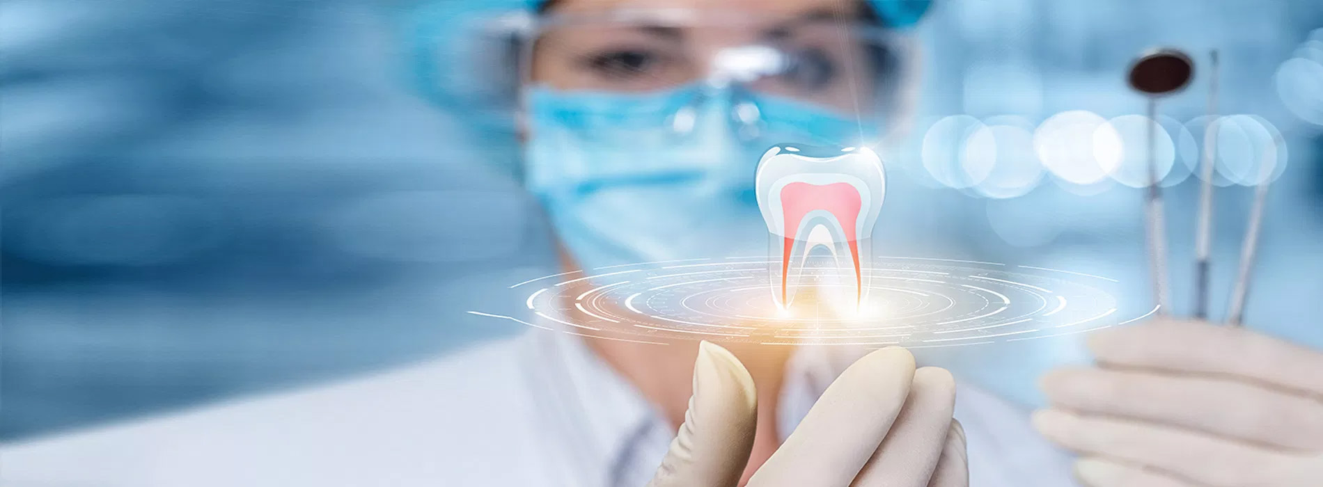 The image depicts a dental professional, possibly a dentist or dental hygienist, holding up a model of a tooth with a light illuminating it.